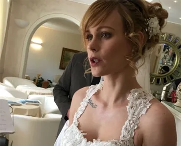 Bride in a white dress speaking in an elegant living room