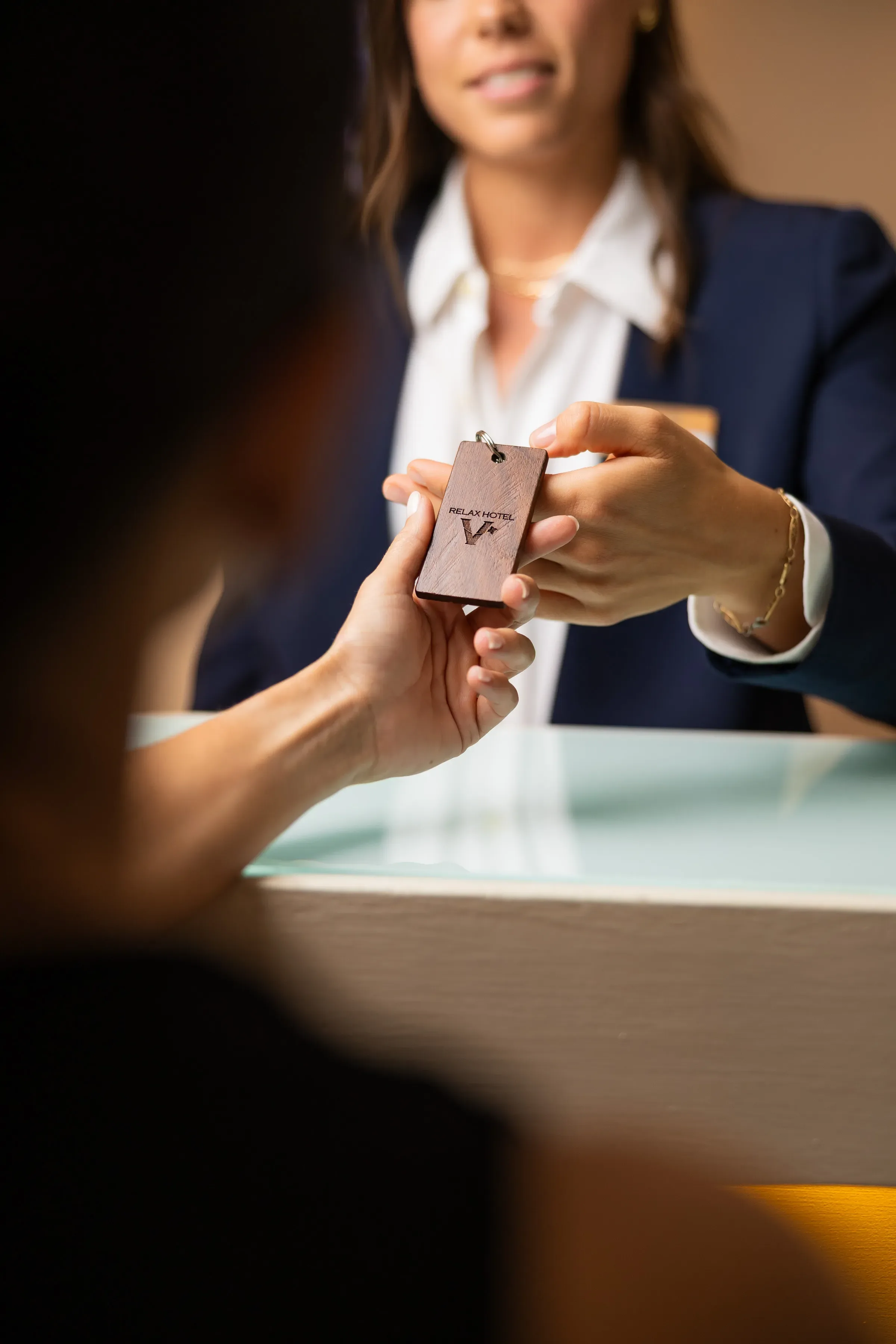 Receptionist handing hotel keycard to guest