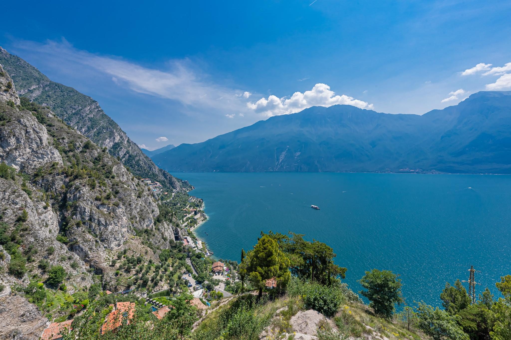 Scenic view of a lake surrounded by mountains with boats on the water